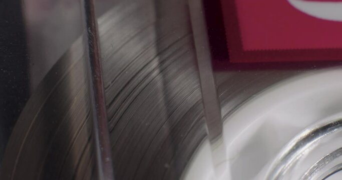 Extreme Close-Up Of Cassette Tape Ribbon Gathering On Reel