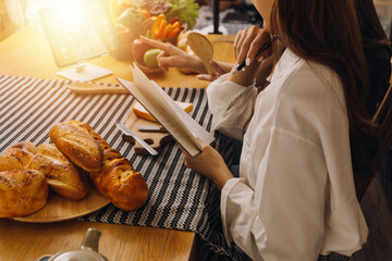 Young woman eating pizza and laughing while sitting with her friends in a restaurant. Group of friends enjoying while having food and drinks at cafe.