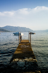 Italian landscape that reflects the dolce vita m summer. after sunset, with palm trees and sea and lake.