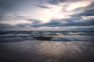 Fototapeta na wymiar Winter sea landscape. Empty wavy sea on a cloudy day.