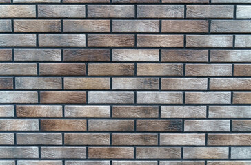 Texture of a wall made of new grey-brown bricks.