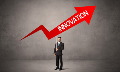 Fototapeta premium Young business person in casual holding road sign