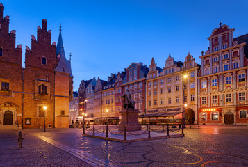View of the market square in Wroclaw with colorful buildings and statue of Alexander Fredro
