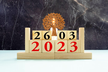 March 26 calendar date text on wooden blocks with blurred park background.
