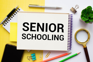 White card with the text Senior Schooling on study desk.