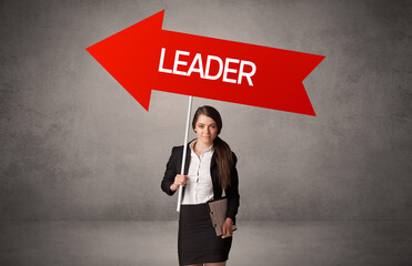 Young business person in casual holding road sign