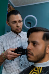 Men's haircut, barber with comb and razor