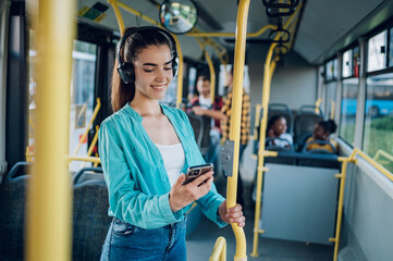 Woman riding in a bus and using a smartphone