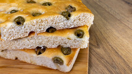 banner or stack of focaccia with olives and oil, healthy mediterranean food, copy space