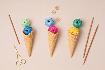 Colorful balls of organic cotton yarn waffle cones for ice cream . Recomforting hobby to reduce...
