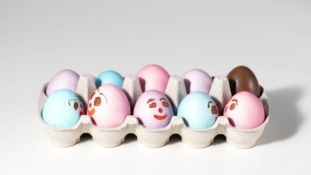 Cute easter eggs with funny faces in box on light background. Happy easter concept. Stop motion easter animation