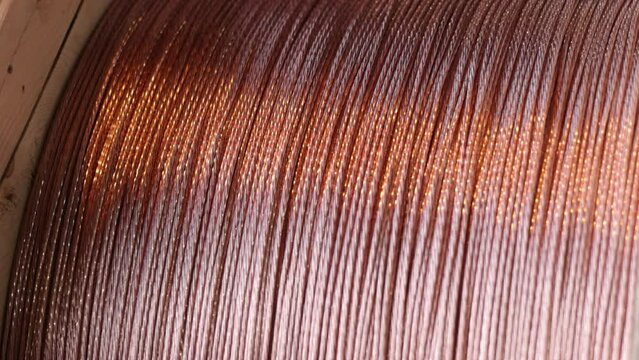Copper wire, cable reels, industry factory. Copper wire and cable are produced in bulk at factory. Factory produces copper wire and cable in large quantities.