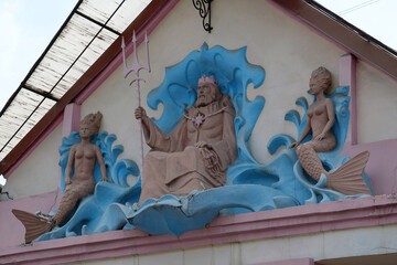 Neptune and mermaids. Bas-relief on old building, Ivano-Frankivsk, Ukraine