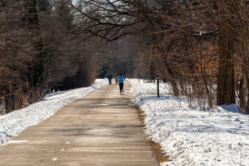 People Enjoying The Fox River Trail Near De Pere, Wisconsin, In Winter Snow