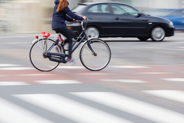 young woman with a bicycle on the move in the city