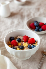 Oat flakes breakfast portion with raspberries, blueberries and honey