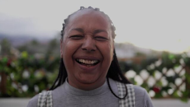 Senior african woman smiling on camera outdoor - Elderly joyful lifestyle concept