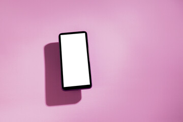 Smartphone with white screen on top of a pink table. Cell phone concept. White screen concept. png