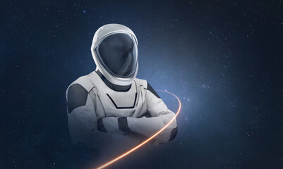 Astronaut with light trail from spaceship on deep space background. Spaceman with stars. Elements of this image furnished by NASA