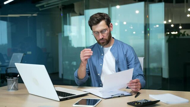 Sad frustrated mature business man freelancer receive mail letter document with bad news failure in project work law order salary reduction investment collapse or dismissal notice at office workplace