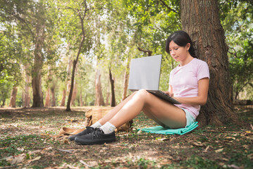 woman working with laptop notebook in forest