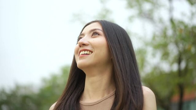 Candid Happy feeling of  Beautiful Young Woman smiling outdoor in sunlight. Pretty face of female and beautiful smile.