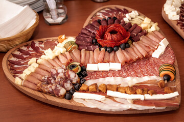 Food decoration on a wooden table. Tasty food on a table. Meat and cheese at the party event.

