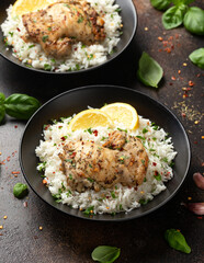 Grilled Chicken thighs served with rice in a black bowl
