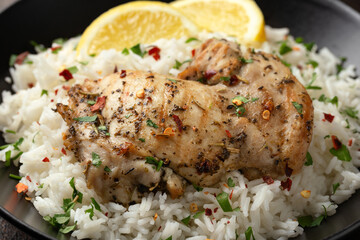 Grilled Chicken thighs served with rice in a black bowl
