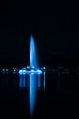 Orlando, Florida fountain at night lighting up Lake Eola  - Vertical Shot