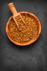 Trigonella foenum-graecum - Dried organic fenugreek seeds in the bowl