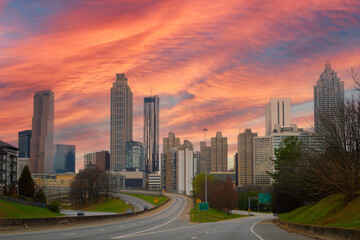 Atlanta City skyline with skyscrapers, buildings, and sunset clouds over the highway in the Capital of the U.S. State of Georgia