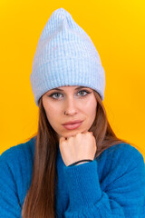 Close up portrait of a young caucasian woman wearing blue wool sweater isolated on background, looking at camera