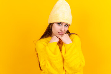 Thinking woman with many ideas with copyspace on yellow background, gesture of thinking or imagining