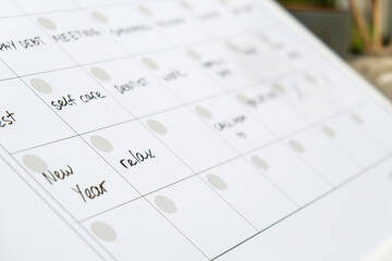 Monthly PLANNER filled with appointments and plans for next month. Busy month schedule. Magnetic board with the days of the month. Place to enter important matters schedule. Concept for business