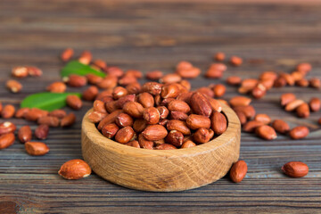 Fresh healthy peanuts in bowl on colored table background. Top view Healthy eating bertholletia concept. Super foods