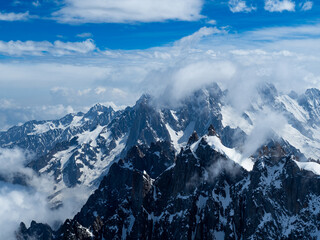 French Alps, peaks of mountains covered with snow. Blue sky and sunny day. Chamonix, France