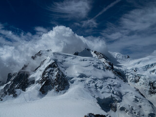 Fototapeta na wymiar French Alps, peaks of mountains covered with snow. Blue sky and sunny day. Chamonix, France
