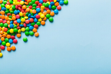 Mixed collection of colorful candy, on colored background. Flat lay, top view. frame of colorful chocolate coated candy