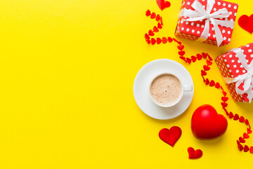 Mug coffee and gift box on colored background. Flat lay composition. Holiday concept