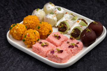 Variety Of Assorted Desi Ghee Indian Mithai viz. Laddu, Kesar Barfi, Kalakand, Kaju Barfi, Gulab Jamun. Traditional Sweet Food for Diwali, Holi, Rakshabandahan, Navaratri, Dussehra, Janmashtami Puja