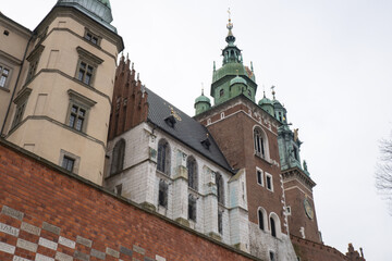 Fototapeta na wymiar Royal Wawel royal castle in Krakow in rainy early spring weather in Poland. historic castle in the old city Gardens and cathedra, Cracow, Poland. Travel attraction tourist destination
