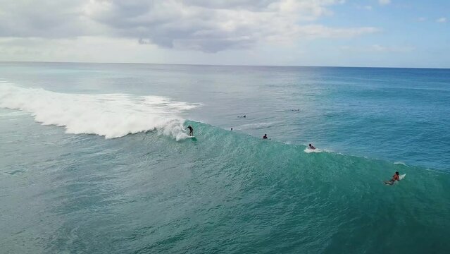 Surfer stalls on take off on wave then pops off the back and returns to lineup