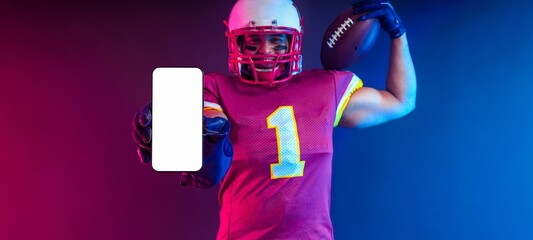 American football player banner with neon lights holding big smartphone with white blank screen in hand. Template for bookmaker ads with copy space. Mockup for betting advertisement.