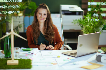 business owner woman in green office working with documents