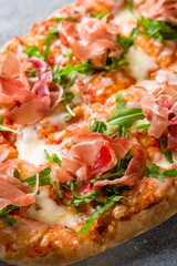 Pinsa with parma ham and aragula, rome pizza. macro close up vertical
