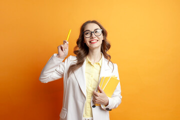 Fototapeta na wymiar business girl in suit holds documents and pointing with pen, female student in blazer dreams and choses