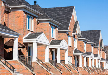 Row of red brick luxury townhouses in residential district.