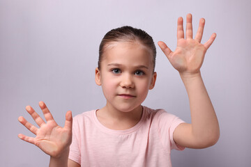 Cute little girl stuck to transparent screen