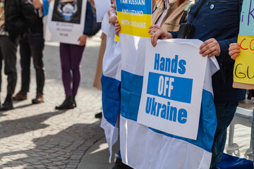 Person holding placards with messages about war between Ukraine and Russia in protest against war...